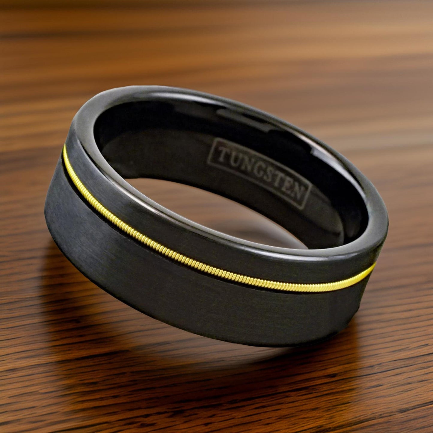 Black wedding ring made with gold guitar strings.