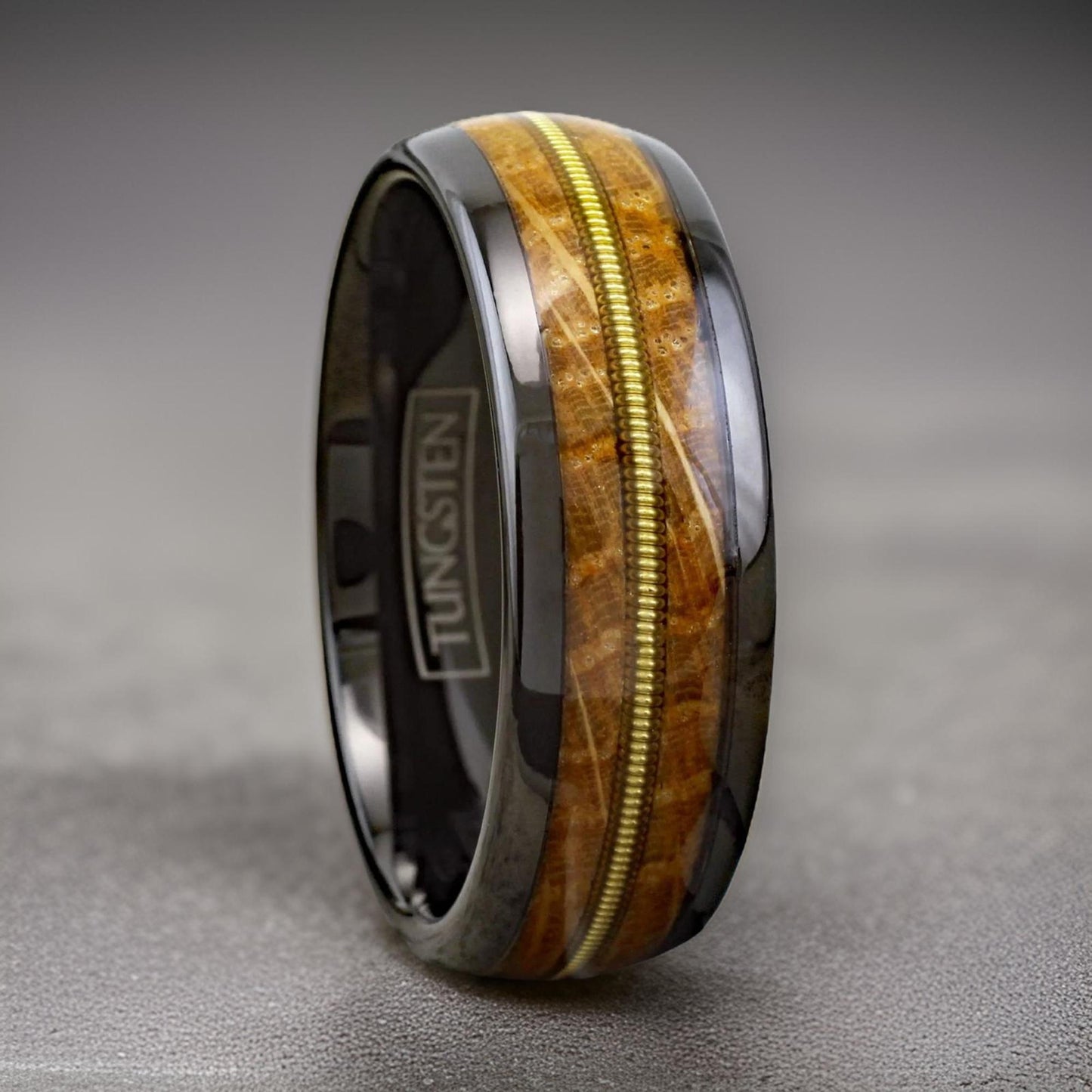 black tungsten ring with whiskey barrel wood and guitar wire inlay