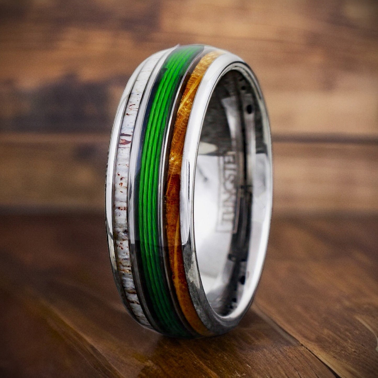 silver ring with antler, fishing line, and whiskey wood